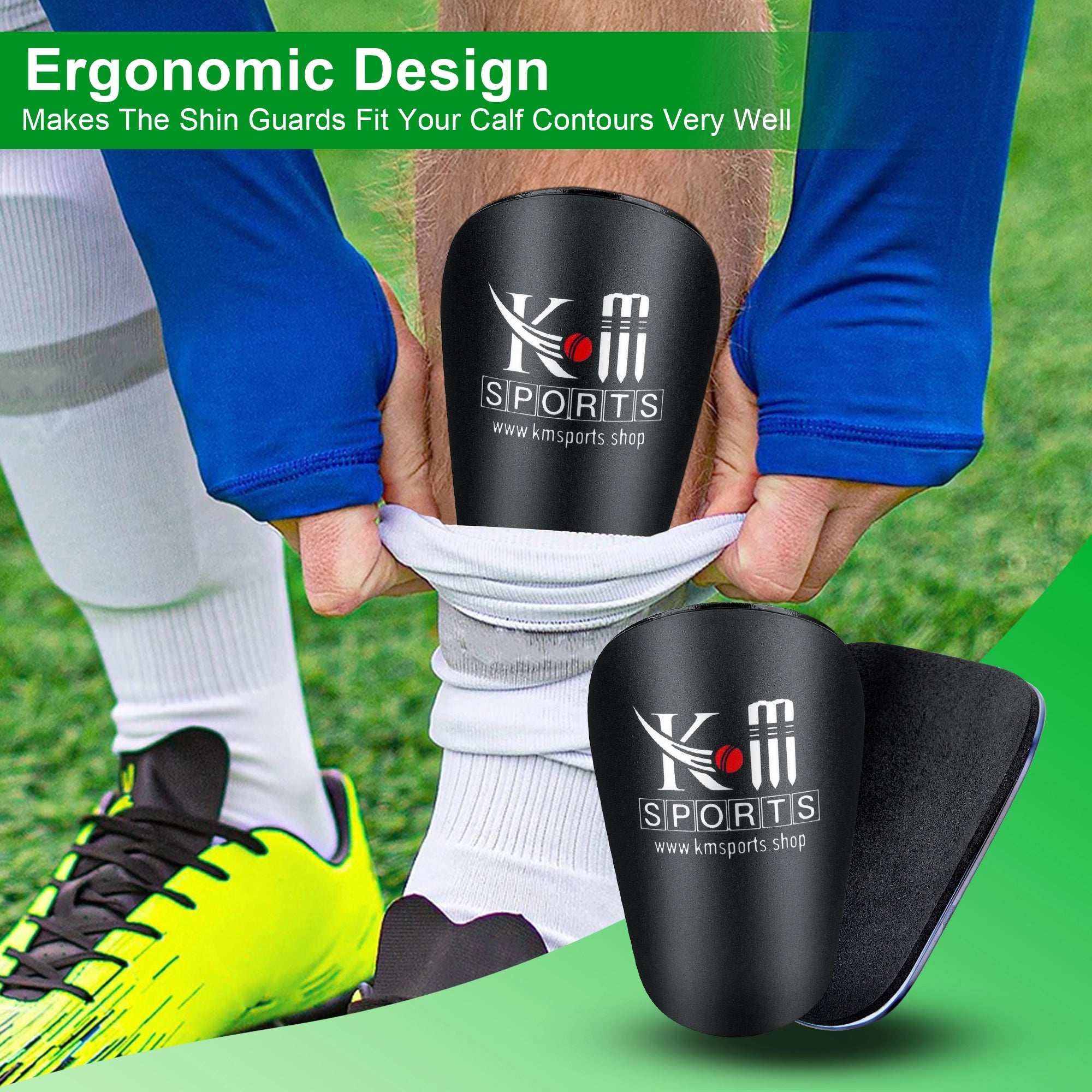 Black shin guards with KM Sports logo being worn on a grass field.